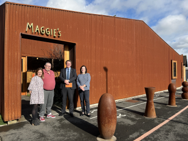 Joel standing with volunteers of Maggie's outside their facility in Whitchurch