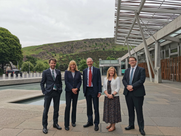 Joel James with Local Government and Housing Committee Members in Holyrood